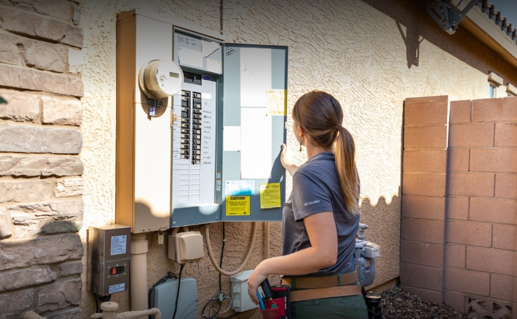 Home Inspector Jen Boekenoogen checking an electrical box 